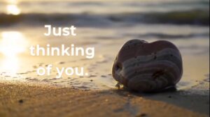 Just Thinking of You, heart rock on a beach scene.